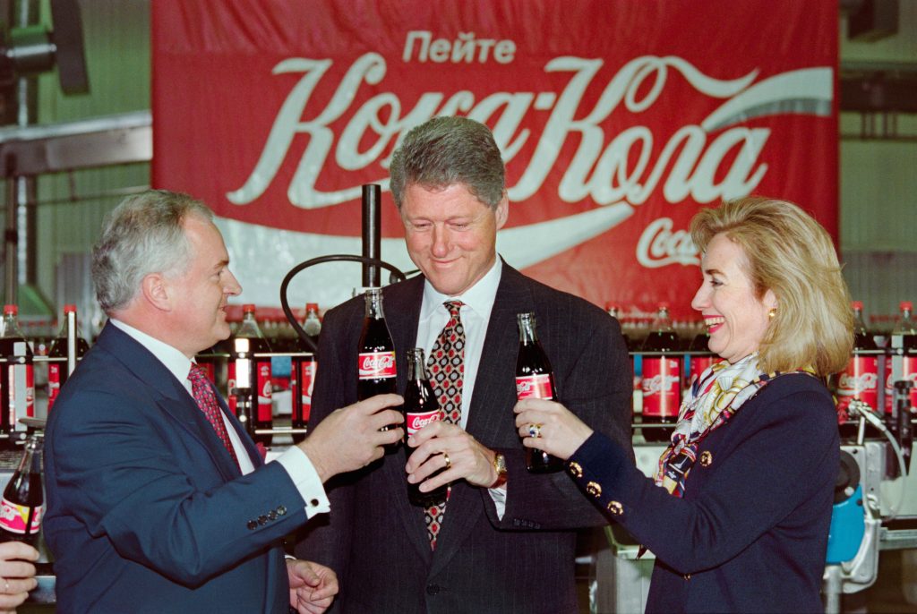 U.S. President Bill Clinton (C), First Lady Hillary Rodham Clinton (R) and Coca-Cola Deputy Region Manager in Russia Michael O’Neill drink a Coca-Cola in Moscow on May 11, 1995, during the Clintons’ visit to the Coca-Cola factory in the Russian capital. YURI KADOBNOV/AFP/GettyImages