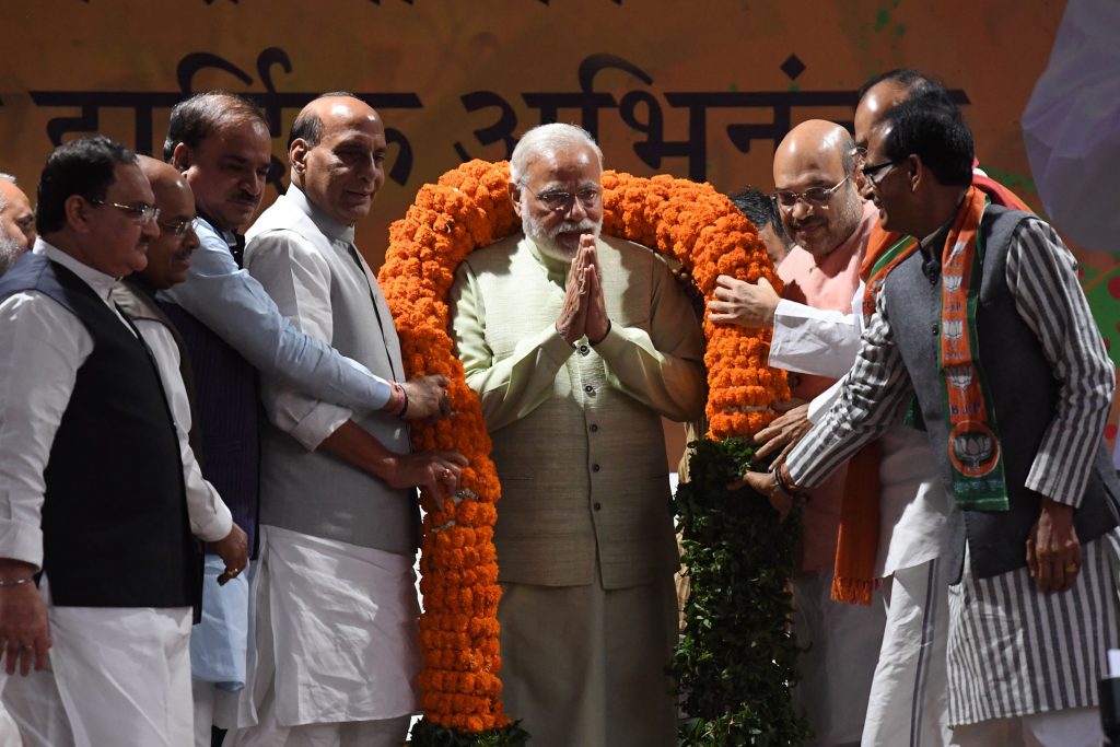 Indian Prime Minister Narendra Modi (C) is greeted on stage at the Bharatiya Janata Party (BJP) headquarters where he delivered a victory speech in New Delhi on March 12, 2017, a day after votes were counted in legislative assembly elections in five Indian states. Narendra Modi's party won a landslide victory in India's most populous state in a massive vote of confidence for the prime minister halfway into his first term. Modi's Hindu nationalist Bharatiya Janata Party won a surprise absolute majority in Uttar Pradesh in the north, which is home to 220 million people and seen as a key indicator of national politics. / AFP PHOTO / Prakash SINGH (Photo credit should read PRAKASH SINGH/AFP/Getty Images)